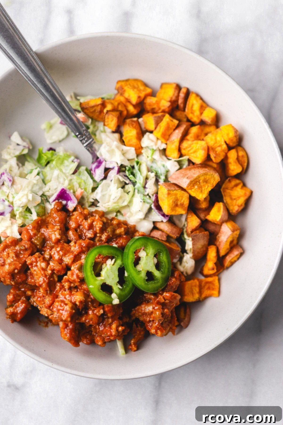 Easy Turkey Sloppy Janes 7 Turkey sloppy joe mix served in a bowl with roasted sweet potato cubes and coleslaw