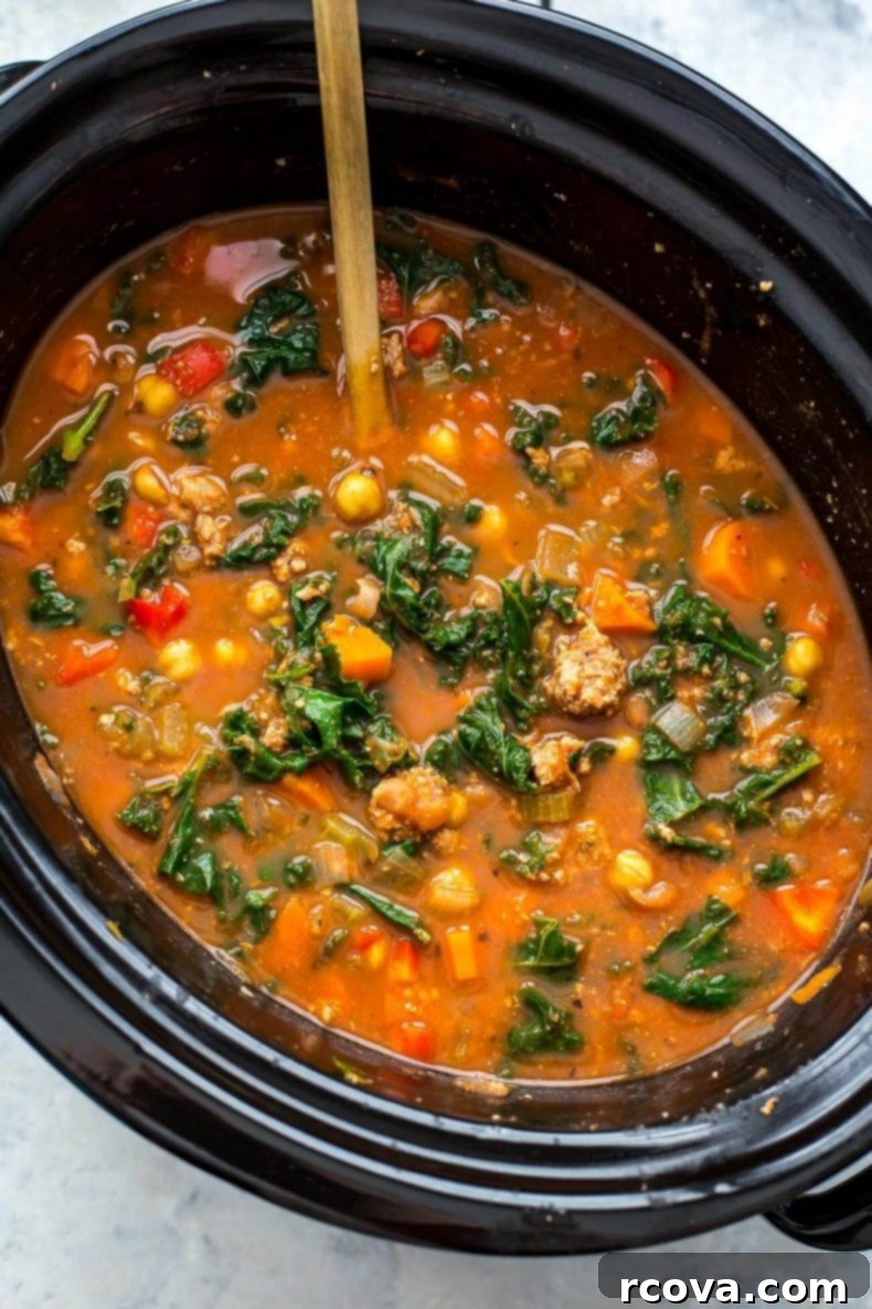 Hearty Tuscan Sausage and Kale Slow Cooker Soup 7 Meal prepped Slow Cooker Tuscan Sausage and Kale Soup in glass containers
