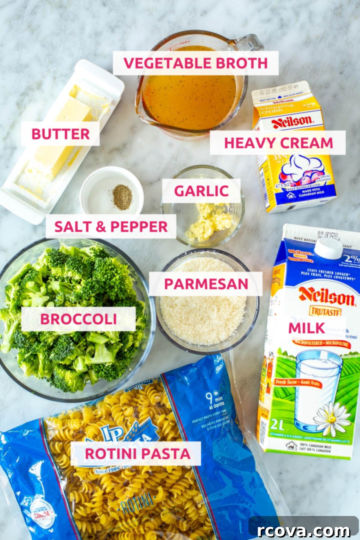 Creamy One-Pot Broccoli Alfredo Pasta 4 A selection of fresh ingredients laid out: rotini pasta, vibrant green broccoli florets, butter, vegetable broth, salt, pepper, garlic cloves, grated Parmesan cheese, milk, and heavy cream.