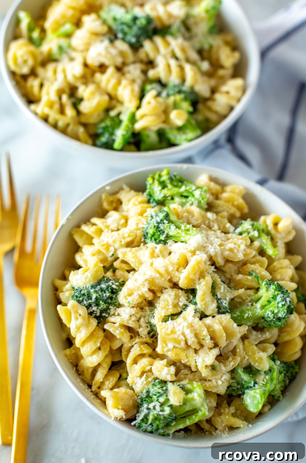 Creamy One-Pot Broccoli Alfredo Pasta 8 A close-up shot showcasing the creamy texture and vibrant broccoli in two bowls of One-Pot Broccoli Alfredo Pasta, ready to eat.