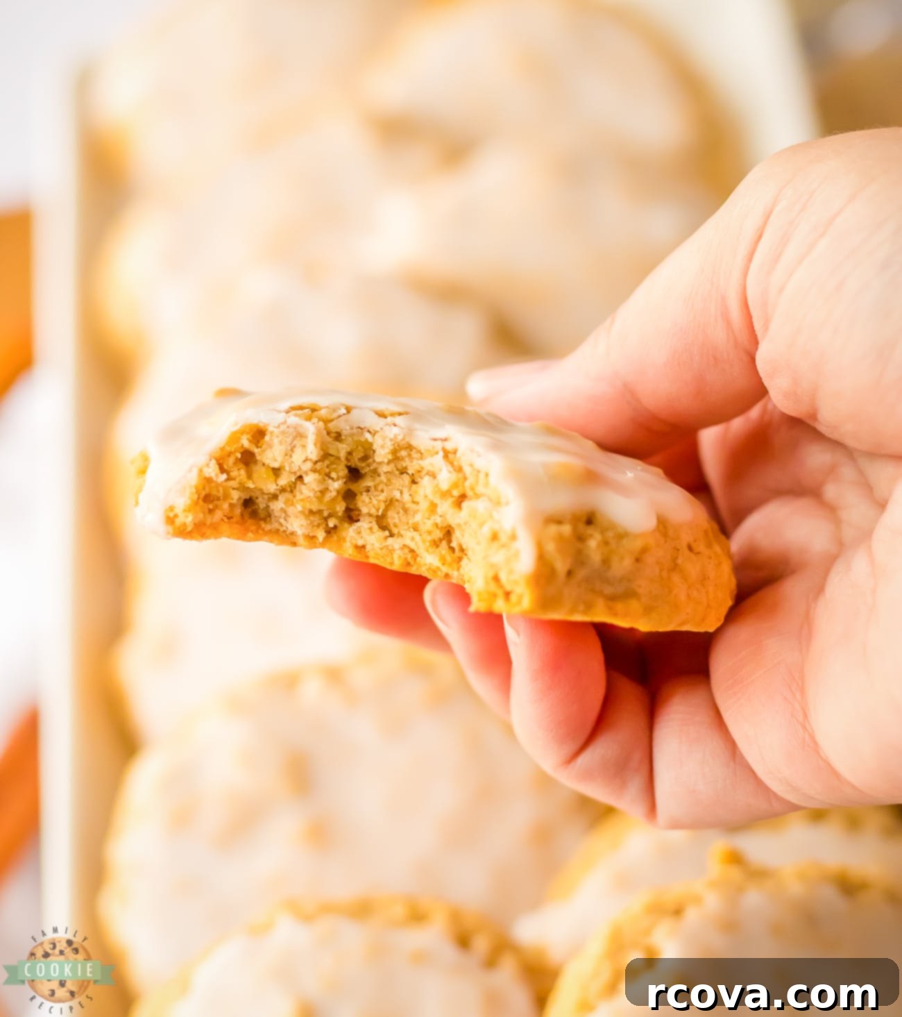 Perfectly Soft and Chewy Glazed Oatmeal Cookies 5 holding an oatmeal cookie with a bite taken out