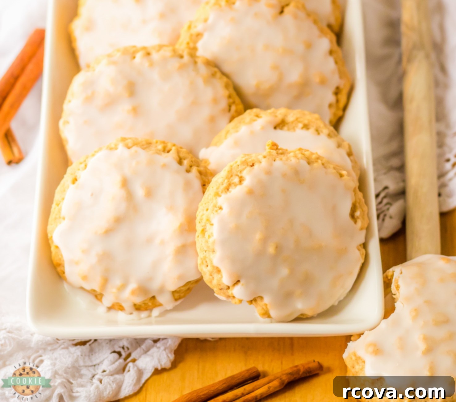 Perfectly Soft and Chewy Glazed Oatmeal Cookies 7 lightly iced oatmeal cookies on a white tray