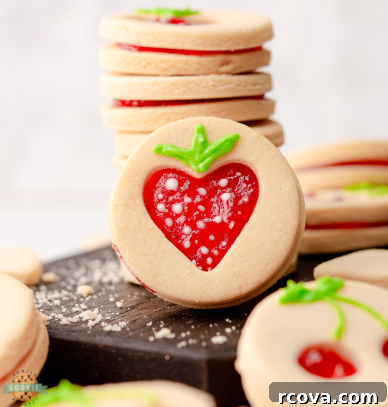 Fruit-Kissed Linzer Cookies 3 A selection of strawberry cut-out Linzer cookies with white chocolate seeds
