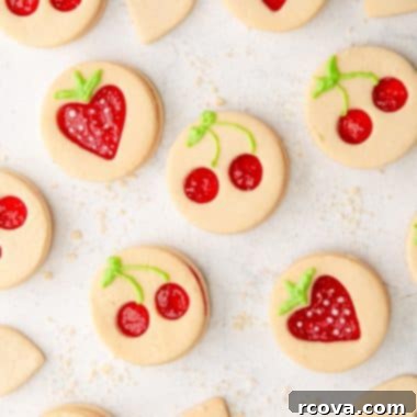 Fruit-Kissed Linzer Cookies 6 fruit shaped linzer cookies with cherry and strawberry cut-outs