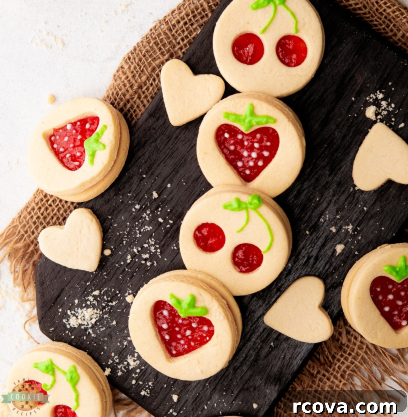 Fruit-Kissed Linzer Cookies 7 Close-up of beautifully decorated fruit-shaped Linzer cookies with jam filling
