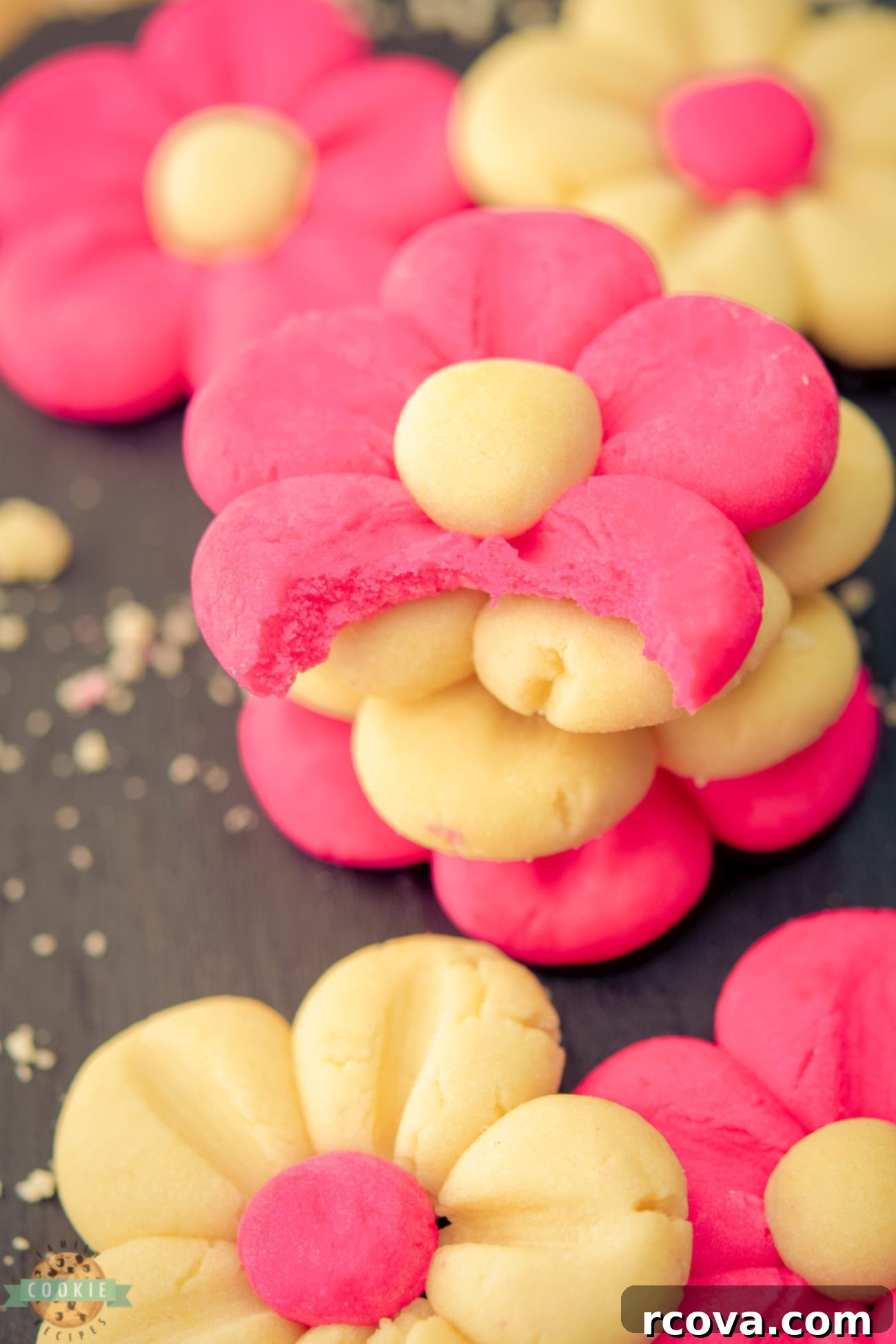 Blushing Daisy Delights 7 pink daisy cookies with a bite taken out