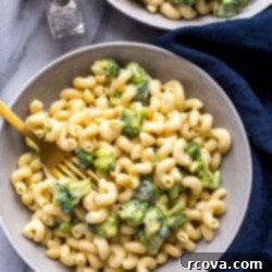 Wholesome Broccoli Mac and Cheese 10 Instant Pot Broccoli Mac and Cheese in a white bowl with a spoon.
