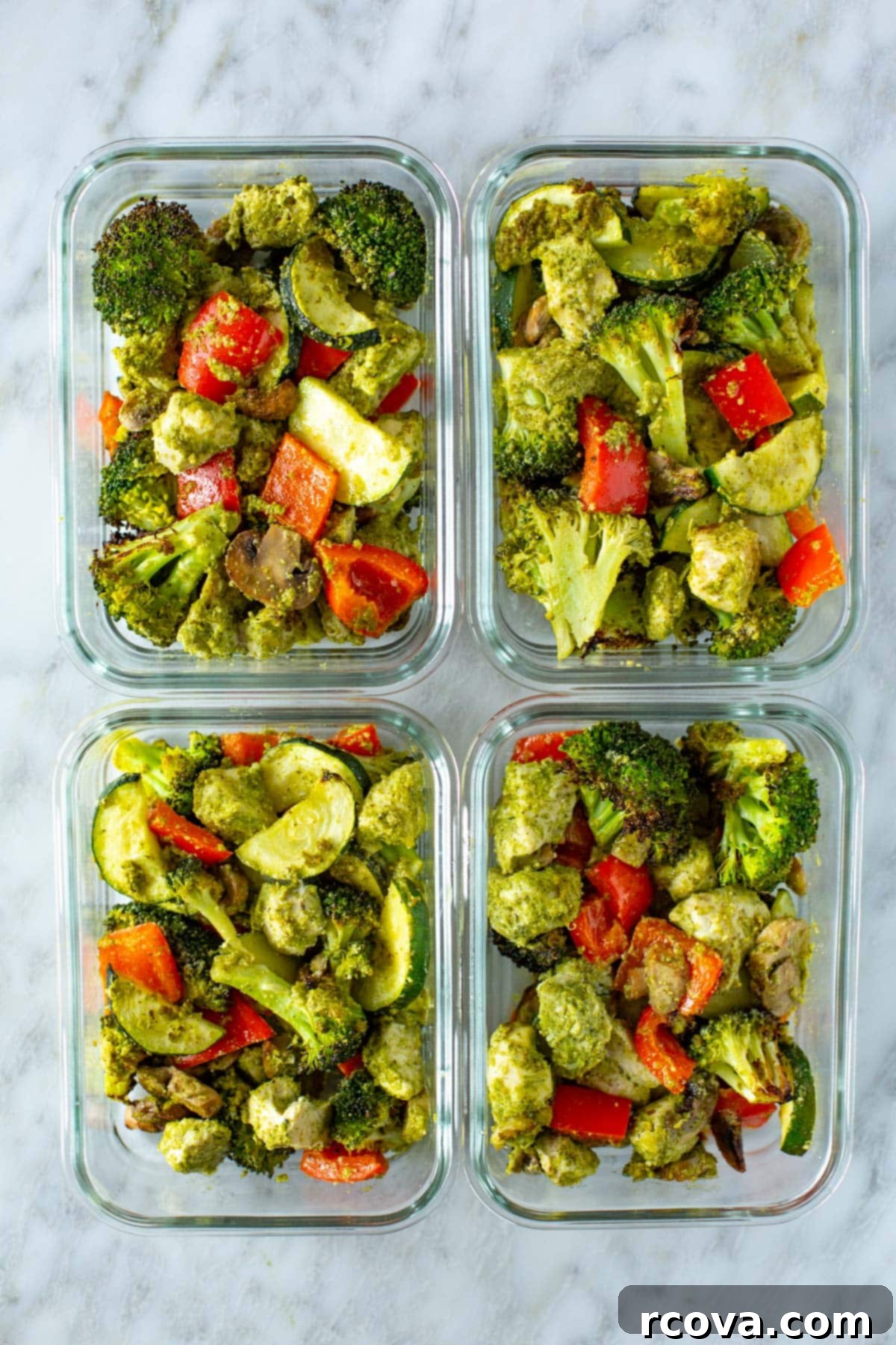 One-Pan Pesto Chicken Dinner 8 Portioned pesto chicken and vegetables in glass meal prep containers, ready for the week.