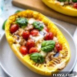 Caprese Chicken Stuffed Spaghetti Squash 9 Close-up of baked Chicken Caprese Spaghetti Squash Boats with melted bocconcini and fresh basil