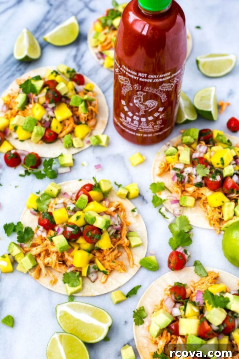 Spicy Instant Pot Sriracha Chicken Tacos 7 A serving of Instant Pot Sriracha Chicken Tacos on a rustic plate, ready to be enjoyed