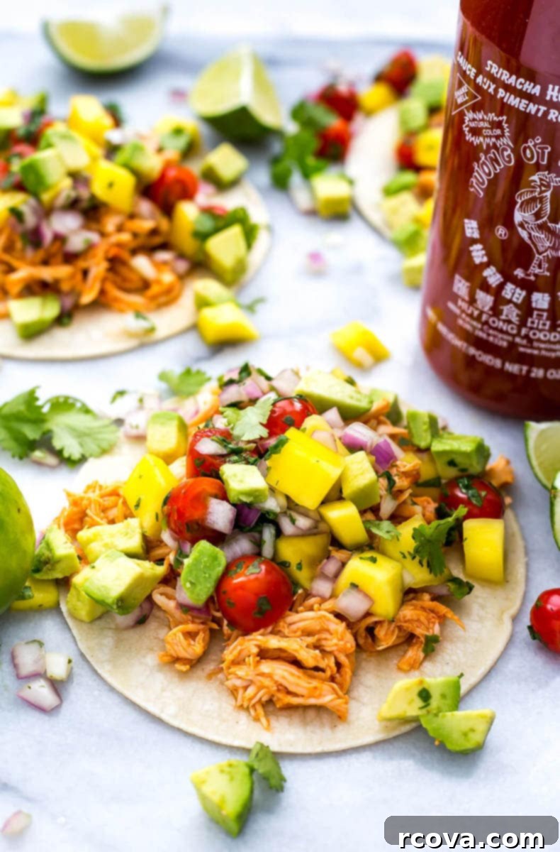 Spicy Instant Pot Sriracha Chicken Tacos 8 A stack of warm tortillas next to a bowl of Instant Pot Sriracha Chicken