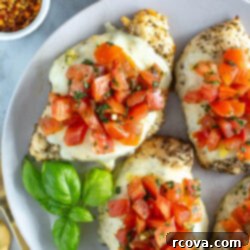 One-Pan Bruschetta Chicken Bake 11 Three chicken breasts with bruschetta on a plate