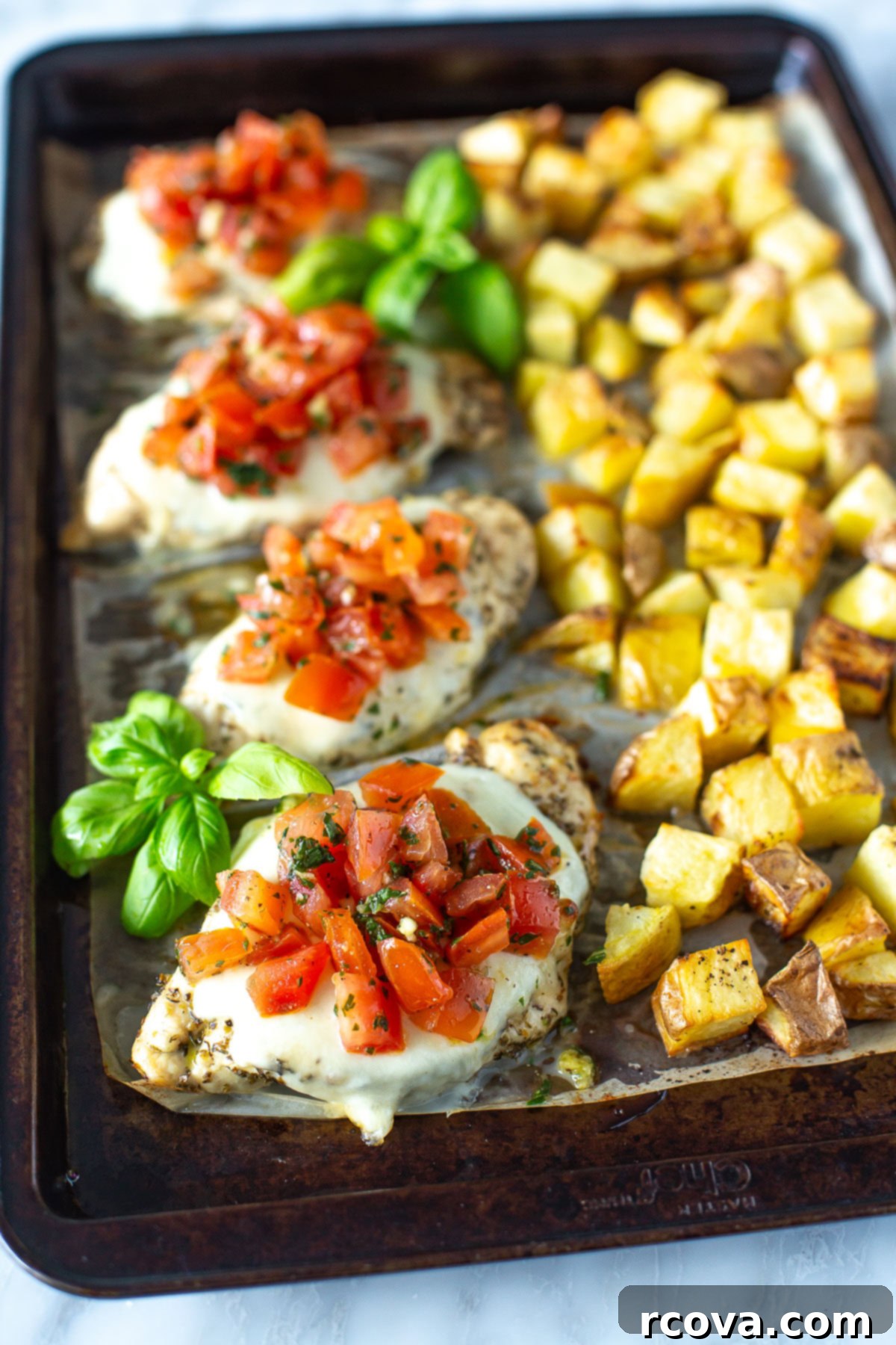 One-Pan Bruschetta Chicken Bake 8 A sheet pan with chicken, potatoes and tomatoes ready to be served
