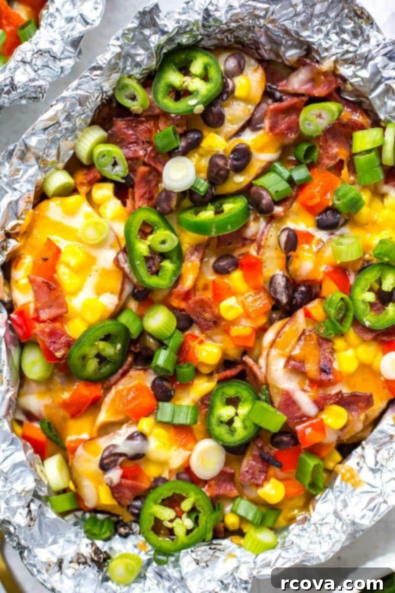 Grilled Cheesy Potato Nacho Packets 6 A foil packet filled with grilled potatoes and melted cheese, ready for more toppings, perfect for a BBQ or casual gathering.