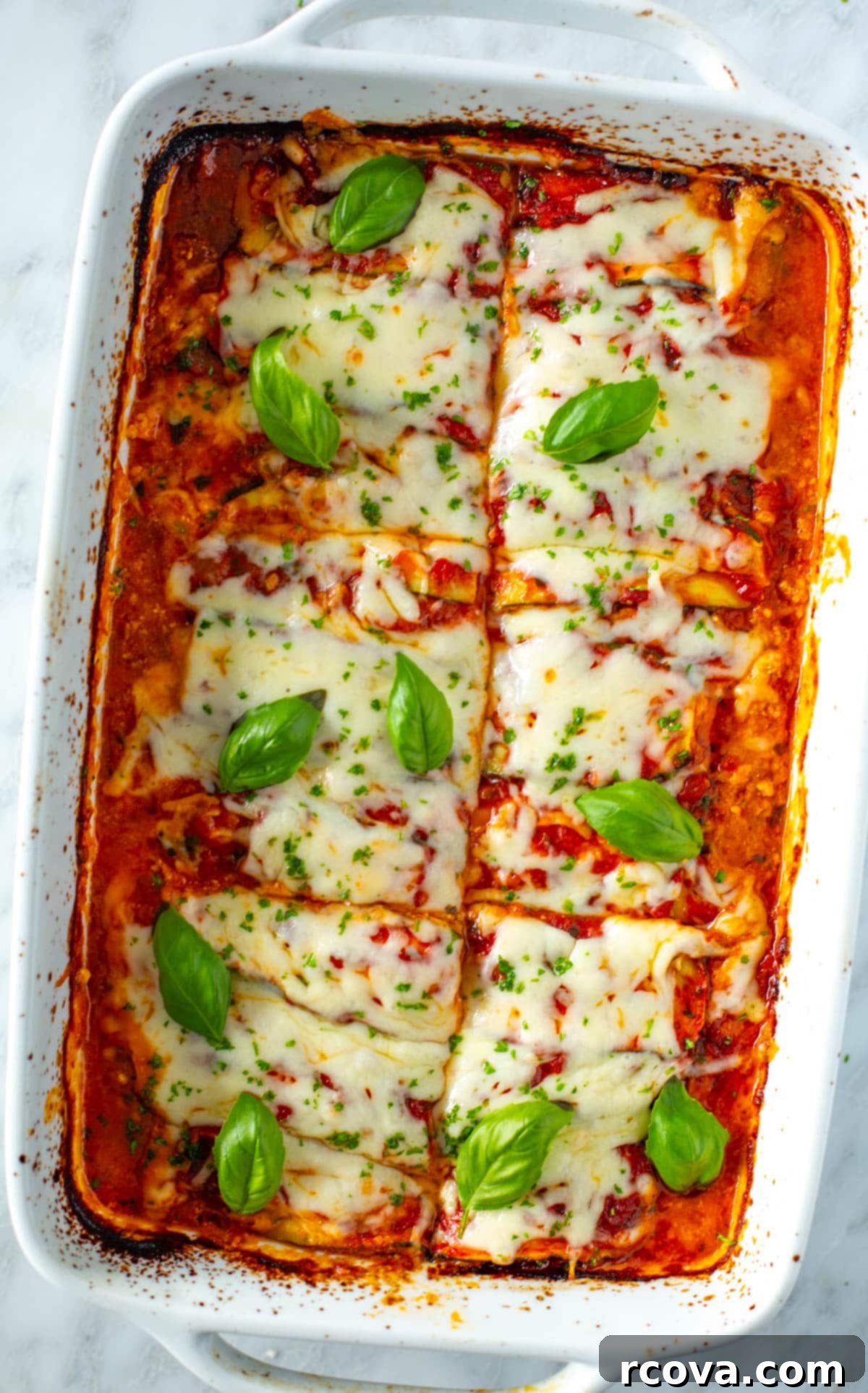20 Effortless Low-Carb Meal Prep Ideas 18 A large white casserole dish with a baked low carb zucchini lasagna.