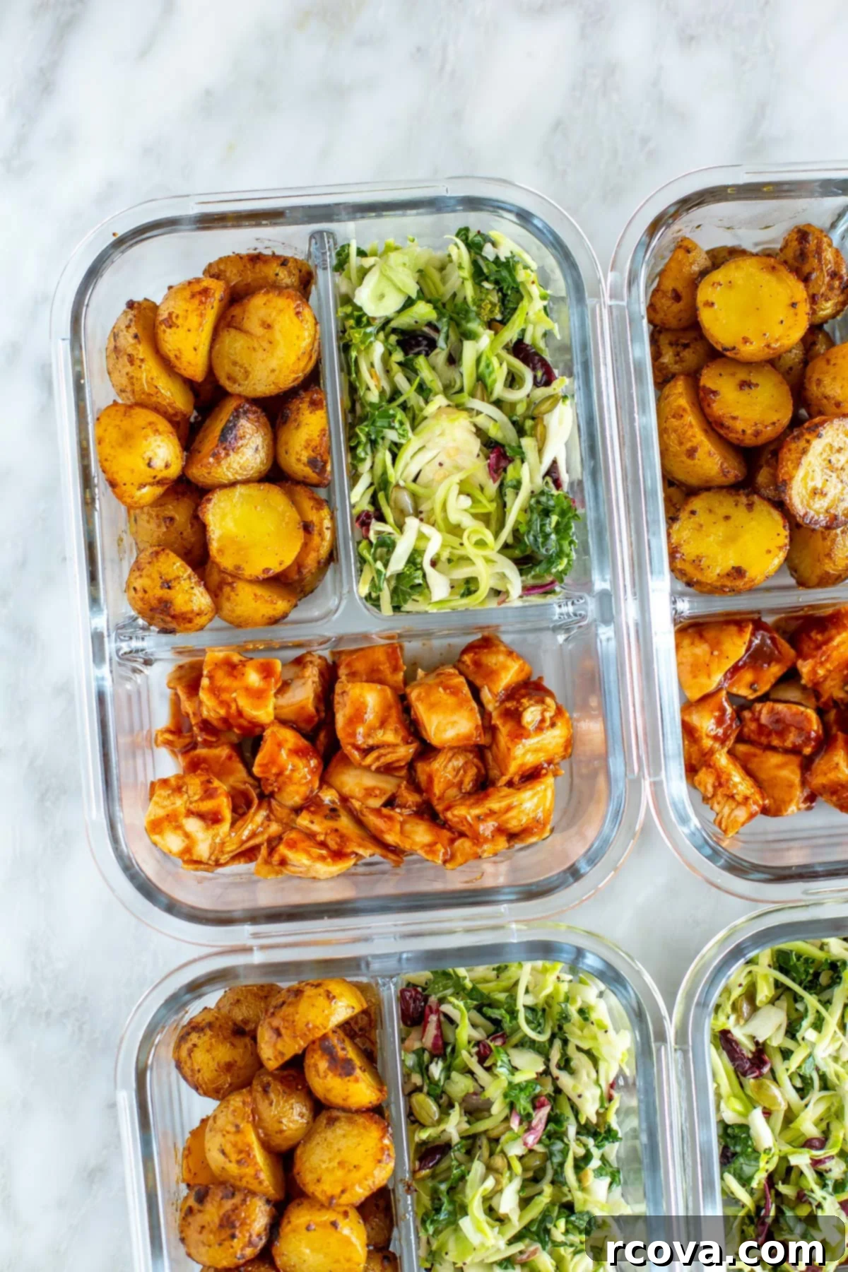 40+ Easy and Healthy Meal Prep Lunches for Work 33 A close-up of a meal prep container with roasted baby potatoes, kale salad, and baked BBQ chicken.