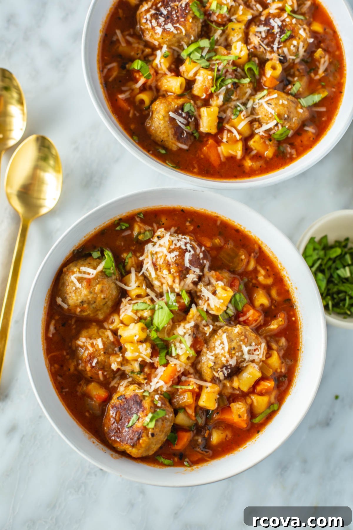 28 Deliciously Healthy Ground Turkey Meals 29 Two bowls of Italian turkey meatball soup with spoons beside them.