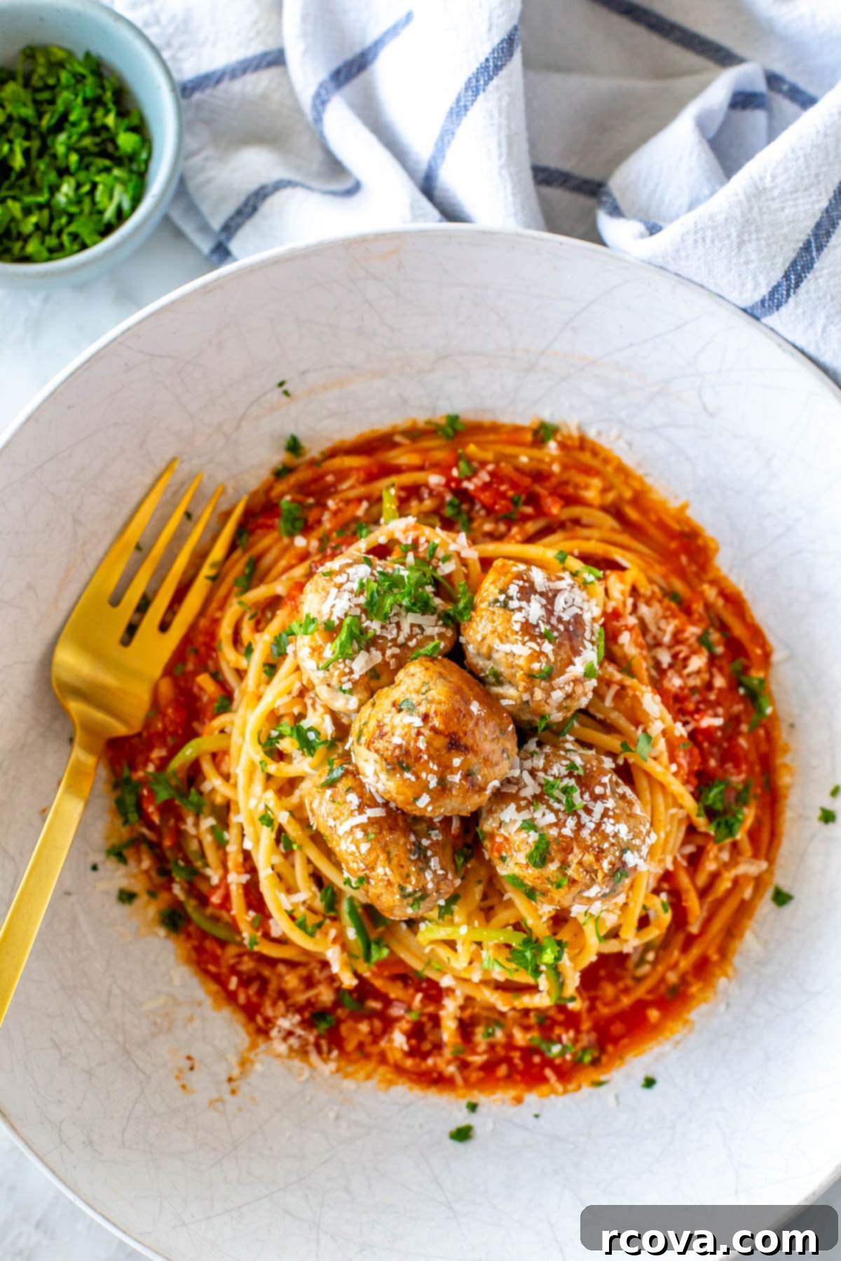 28 Deliciously Healthy Ground Turkey Meals 4 Baked turkey meatballs on a plate of pasta and zucchini.