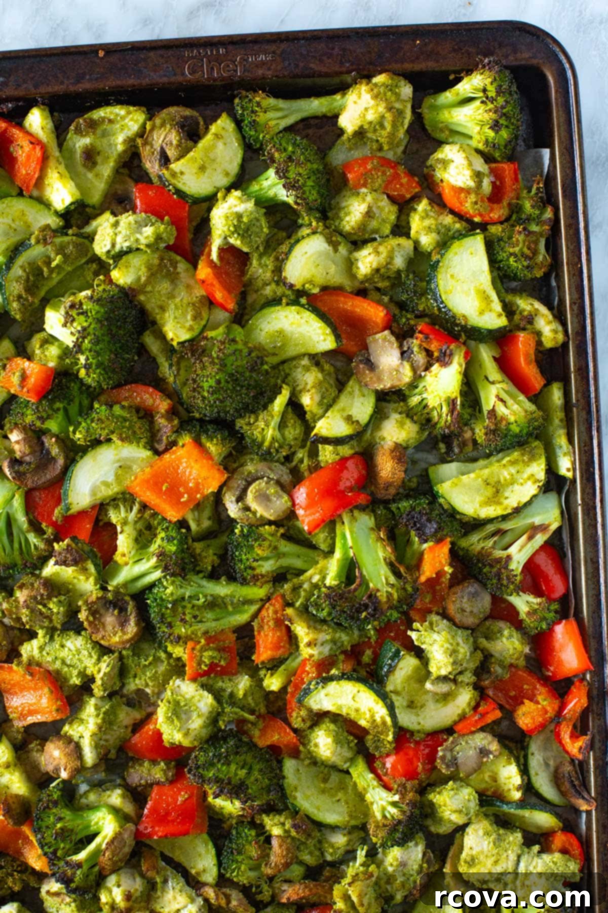 Sheet Pan Magic: Effortless Dinner Ideas 16 Close-up shot of sheet pan pesto chicken with cherry tomatoes and green beans