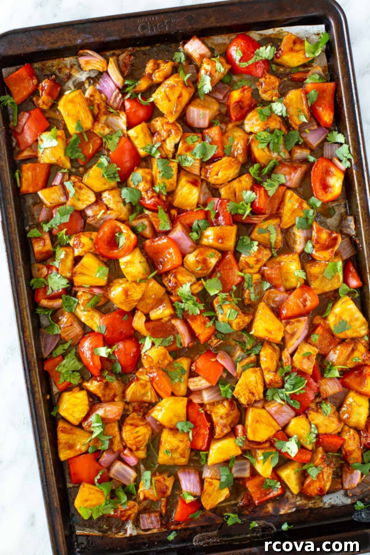 Sheet Pan Magic: Effortless Dinner Ideas 20 Overhead shot of Hawaiian chicken in a sheet pan with pineapple and bell peppers