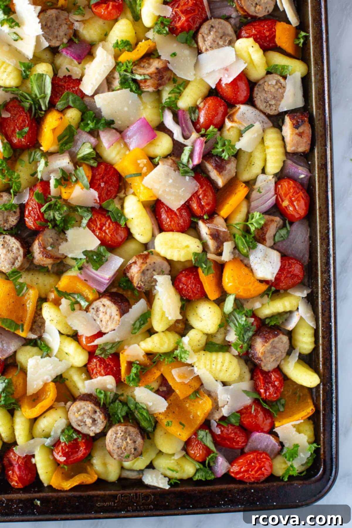 Sheet Pan Magic: Effortless Dinner Ideas 5 Sheet pan gnocchi with sausage, garnished with fresh basil and shaved parmesan cheese