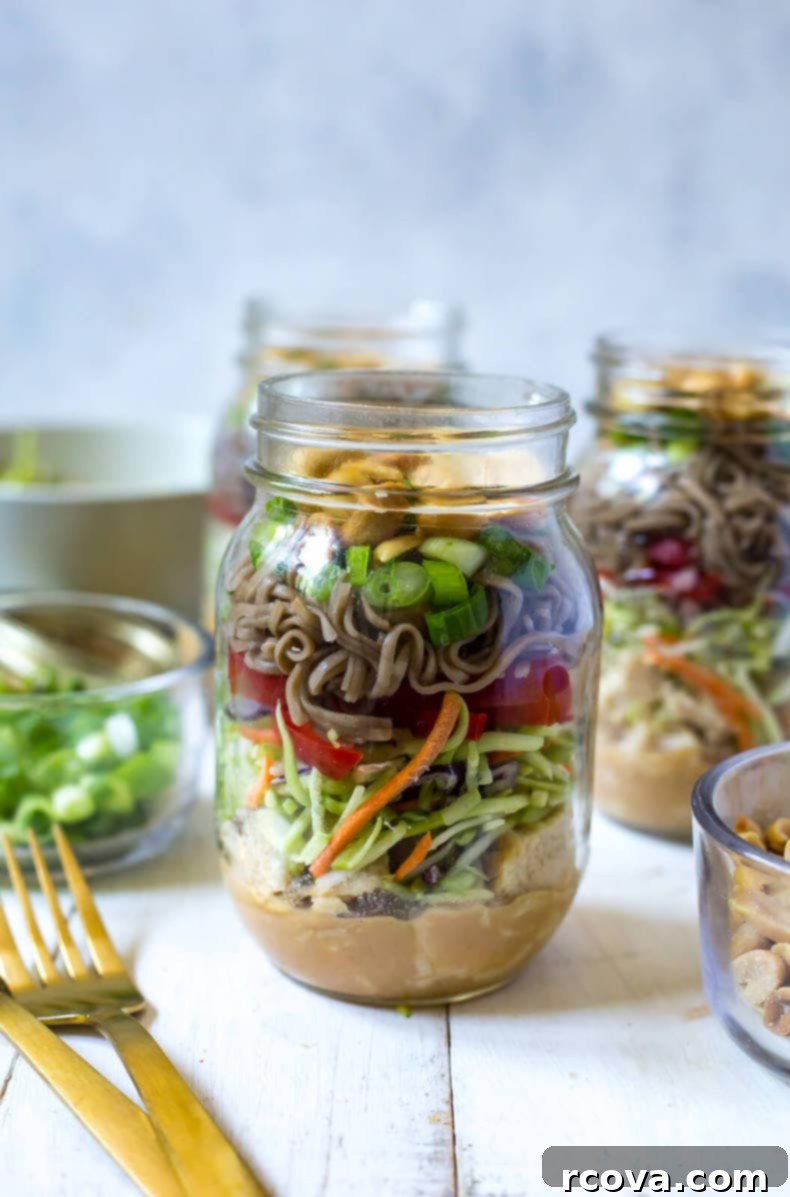 Zesty Thai Chicken Soba Jars 6 Adding vegetables and soba noodles to the salad jars