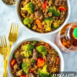 Quick Instant Pot Beef and Broccoli with Rice 10 Two bowls of Instant Pot beef and broccoli with a bottle of sriracha on the side.