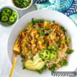 Effortless Instant Pot and Slow Cooker Salsa Verde Chicken 10 A bowl of salsa verde chicken served over rice.