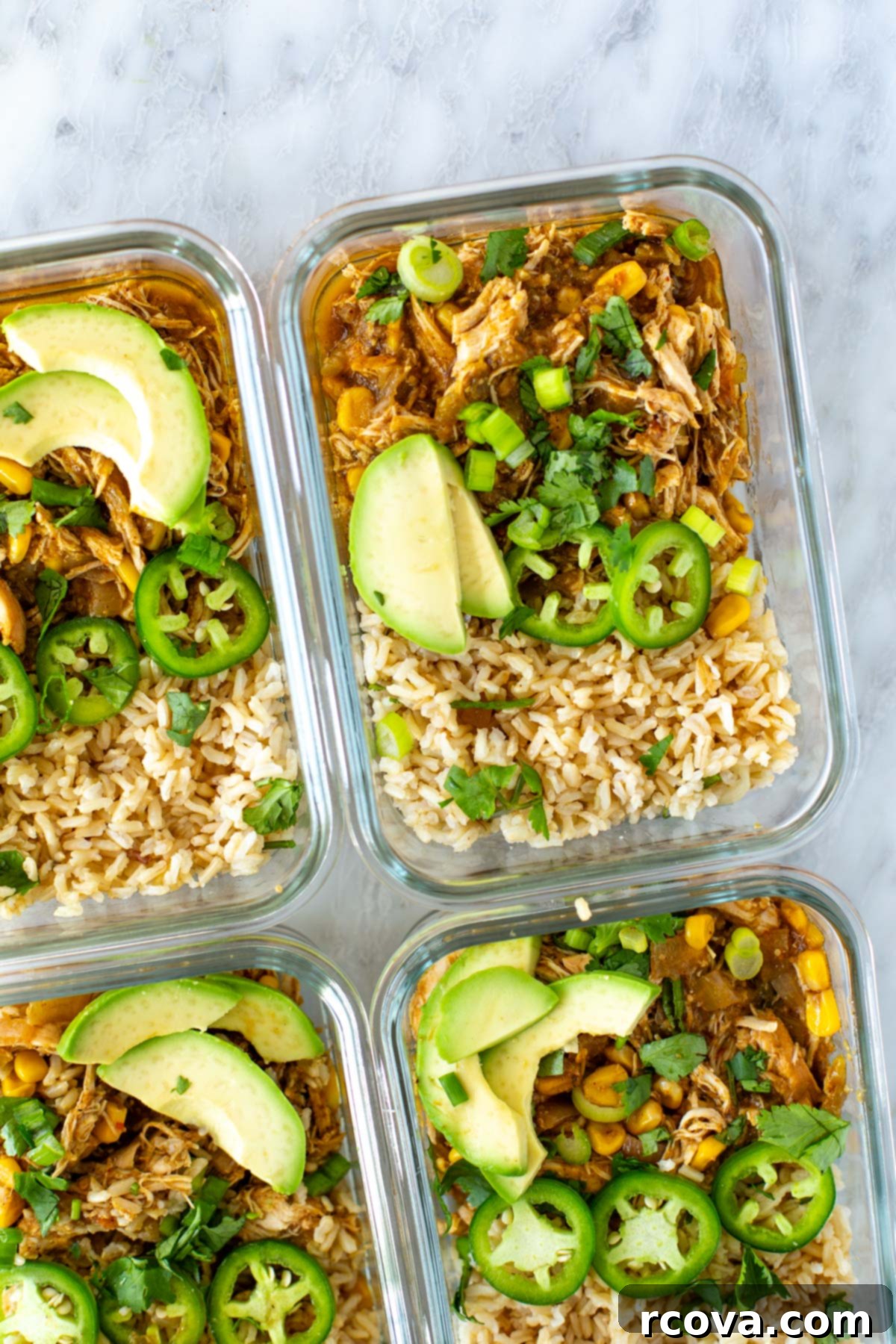 Effortless Instant Pot and Slow Cooker Salsa Verde Chicken 8 A close-up of salsa verde chicken and rice stored in clear glass meal prep containers.