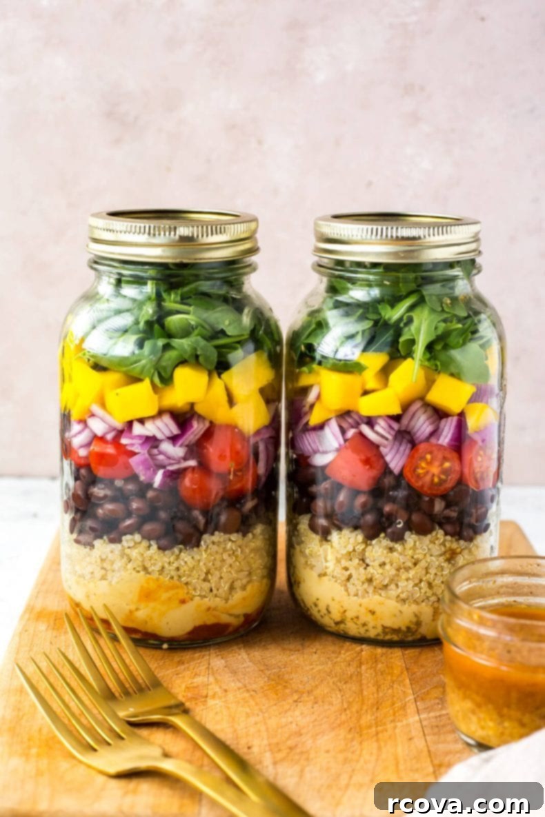Ultimate Veggie Mason Jar Salad Two Ways 5 Close-up of a vegetarian mason jar salad showing distinct layers of ingredients.