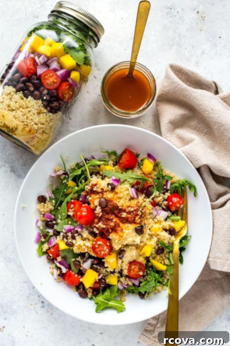 Ultimate Veggie Mason Jar Salad Two Ways 6 A selection of vegetarian mason jar salads neatly lined up, showcasing colorful layers and ready for healthy meal prep.