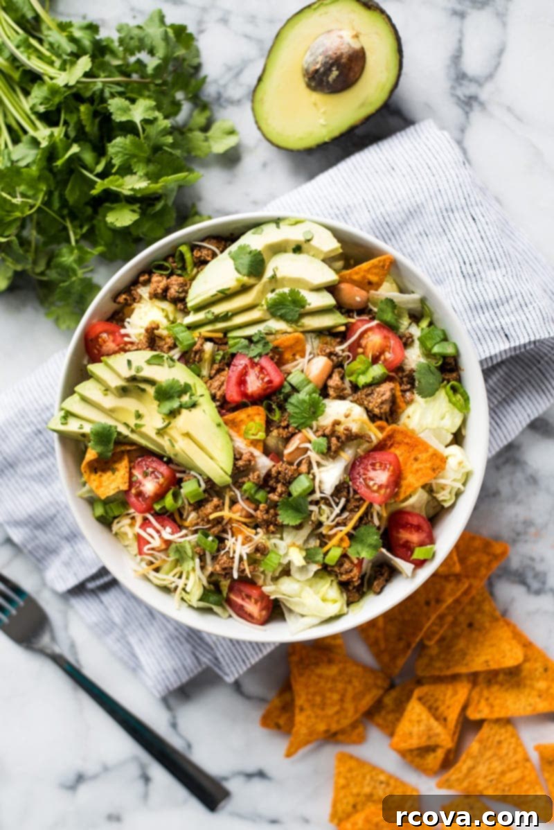 30+ Flavor-Packed Meal Prep Salads You'll Crave 20 The BEST Taco Salad Recipe {Ready in Only 25 Minutes!} via Isabel Eats, topped with Doritos.