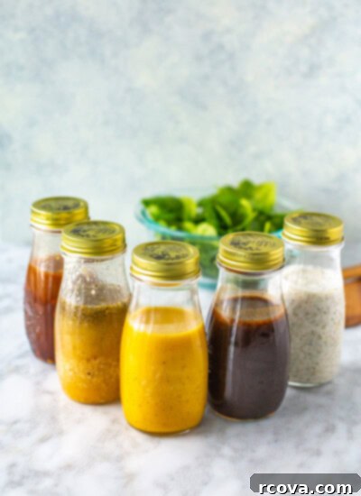 30+ Flavor-Packed Meal Prep Salads You'll Crave 38 A collection of homemade salad dressings in glass jars, showcasing their freshness.