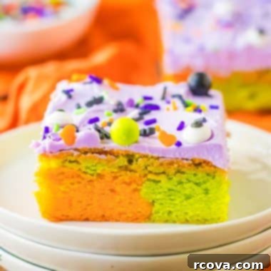 Festive Halloween Sugar Cookie Bars 7 marbled orange and green Halloween sugar cookie bars with purple frosting on a plate