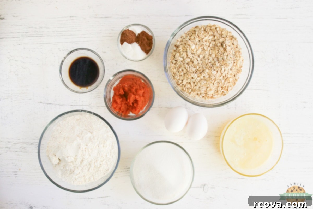 Sweet Glazed Pumpkin Oat Delights 4 A selection of raw ingredients laid out, featuring pumpkin puree, oats, flour, spices, butter, and eggs, ready for making pumpkin oatmeal cookies.
