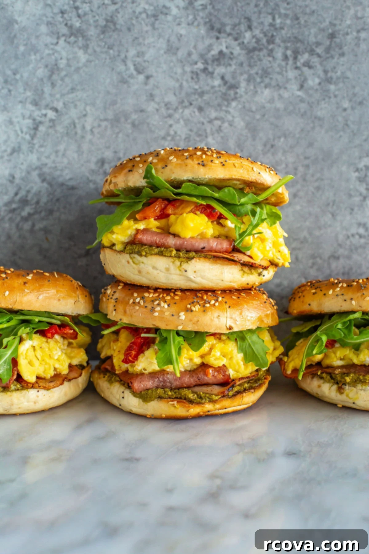 Fuel Your Mornings: Healthy Breakfast Prep 30 Four pesto breakfast bagel sandwiches together.