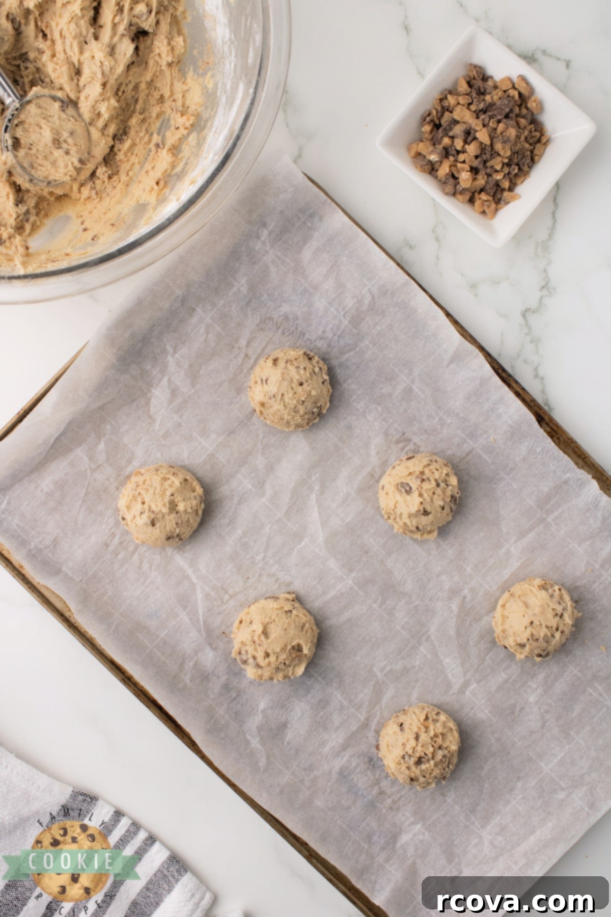 Homemade Heath Bar Crunch Cookies 9 Scooping uniform portions of Heath Bar cookie dough onto a baking sheet.