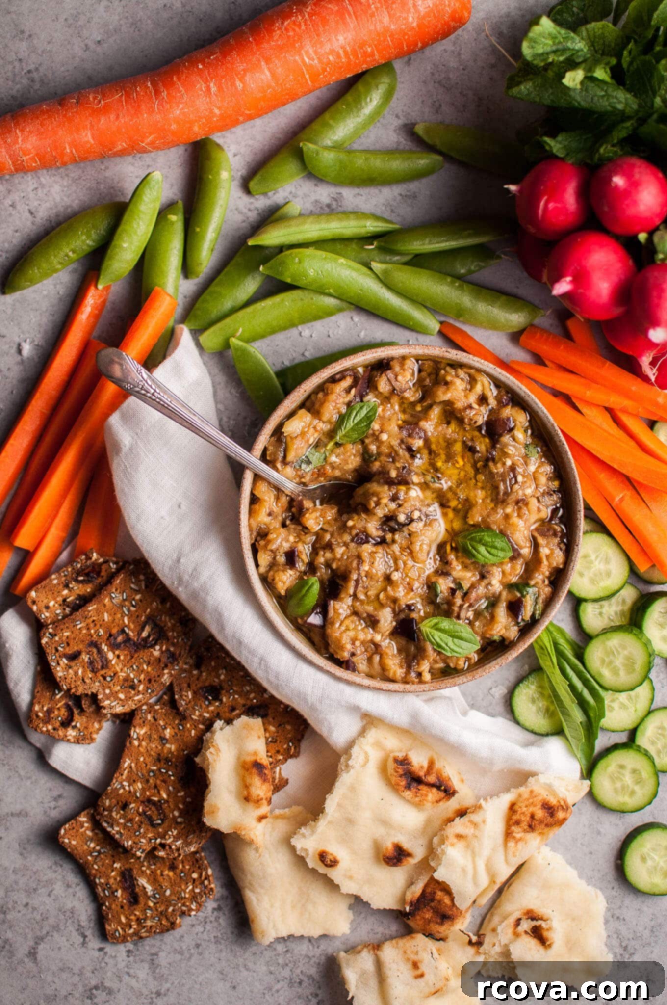 25+ Healthy Grab and Go Work Snacks 19 Roasted Eggplant Dip via Salt & Lavender, served with pita bread.