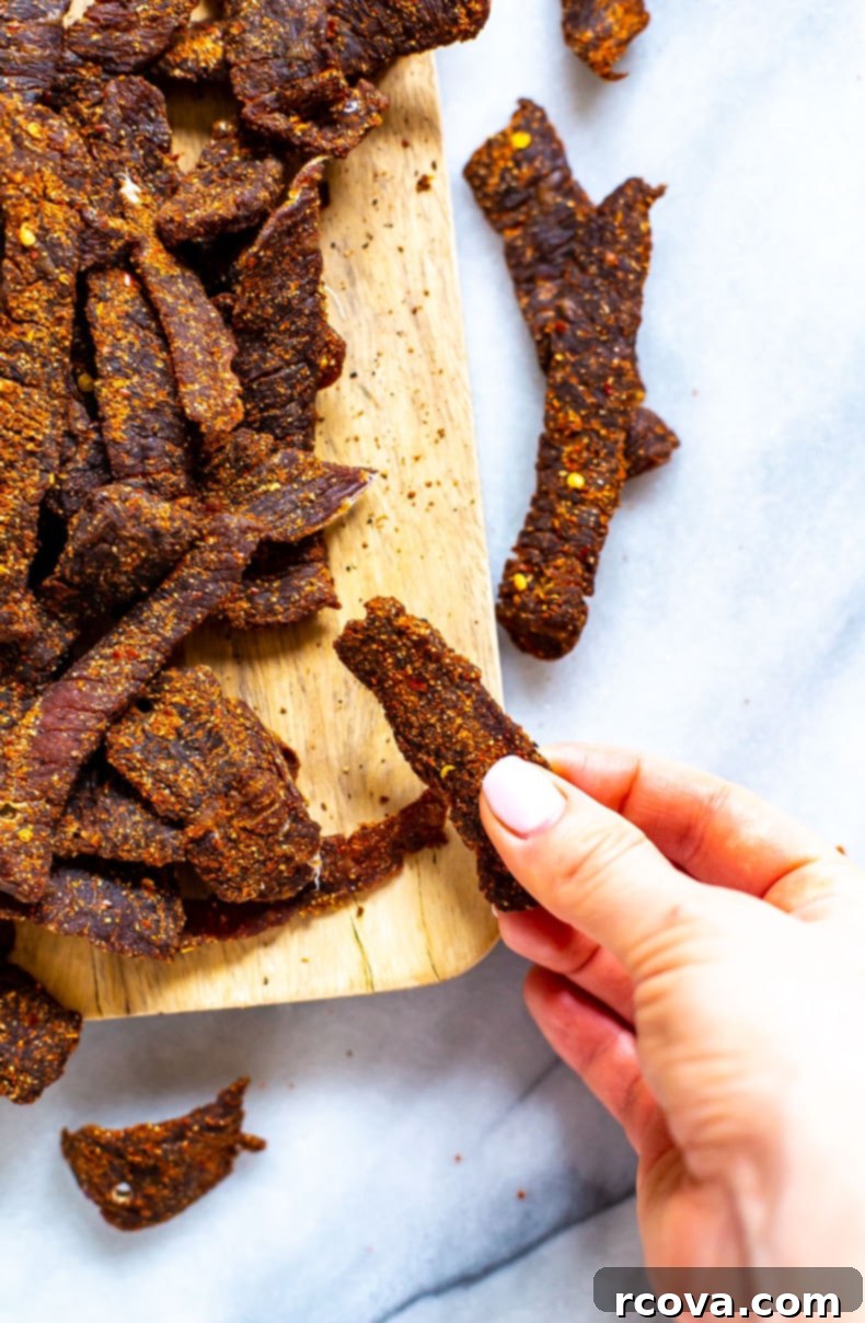 25+ Healthy Grab and Go Work Snacks 24 Homemade Beef Jerky Recipe pieces on a plate.