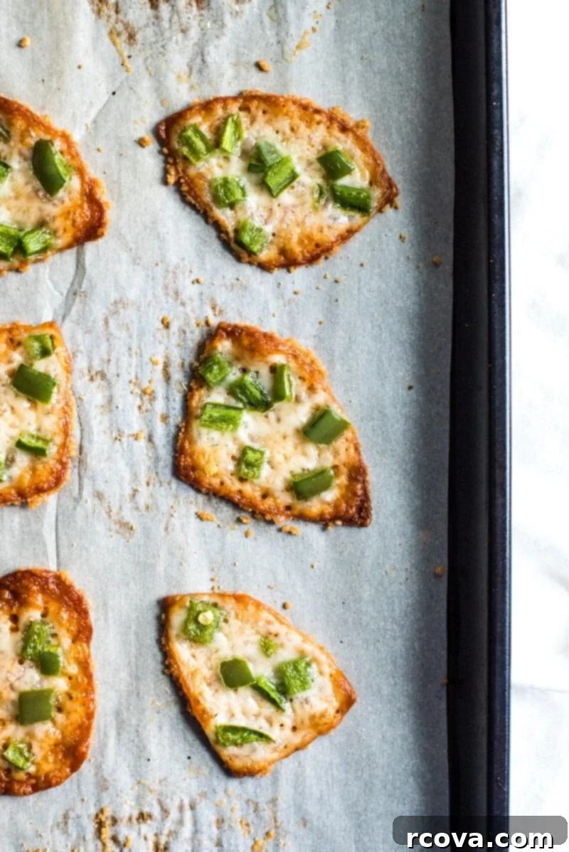 25+ Healthy Grab and Go Work Snacks 29 Jalapeno Parmesan Crisps via Isabel Eats, stacked on a plate.