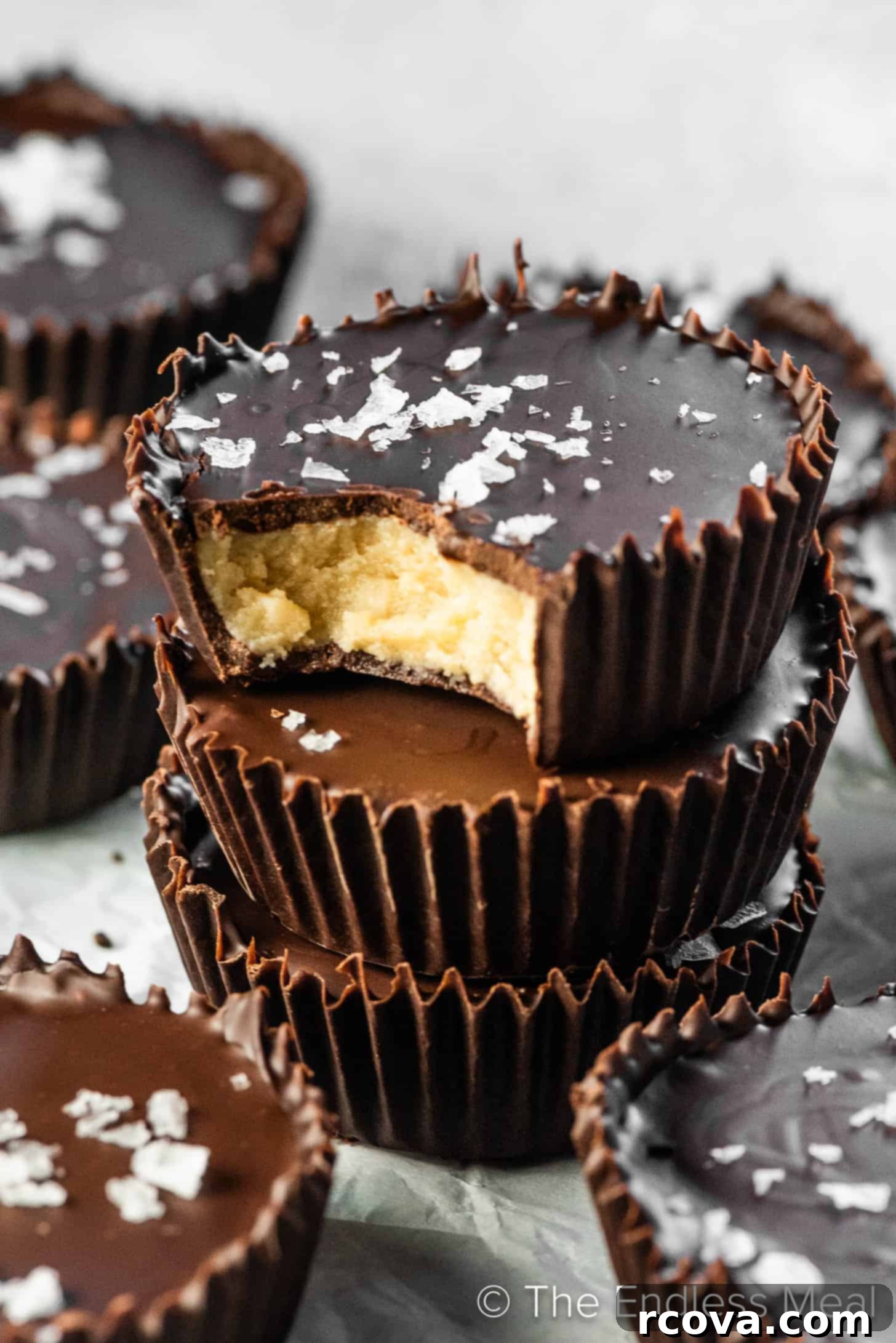 25+ Healthy Grab and Go Work Snacks 9 Vanilla Cashew Butter Cups via The Endless Meal, drizzled with chocolate.