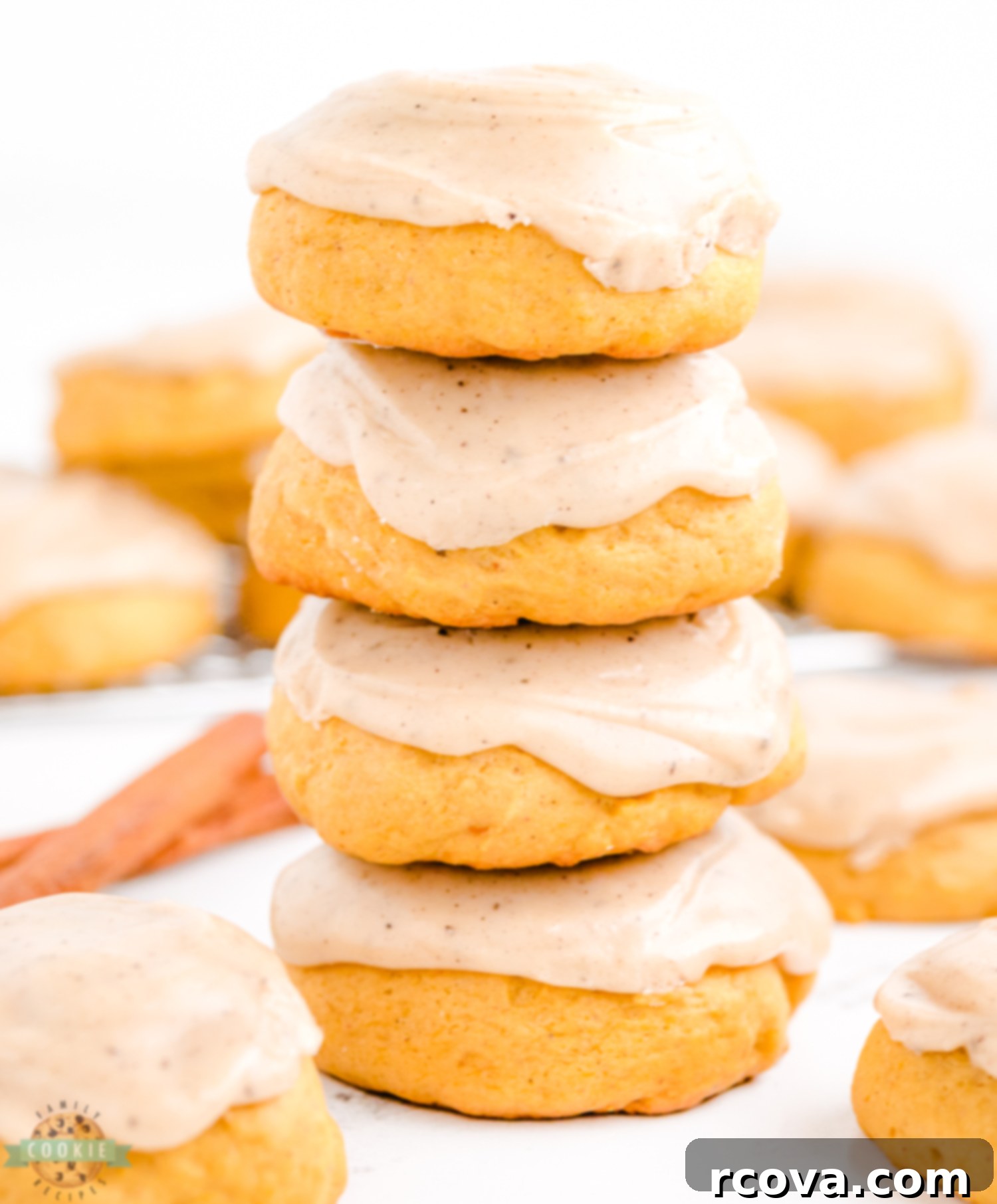 Spiced Frosted Pumpkin Ginger Cookies 3 A charming stack of several soft pumpkin ginger cookies, each generously frosted, ready to be enjoyed as a perfect fall treat.