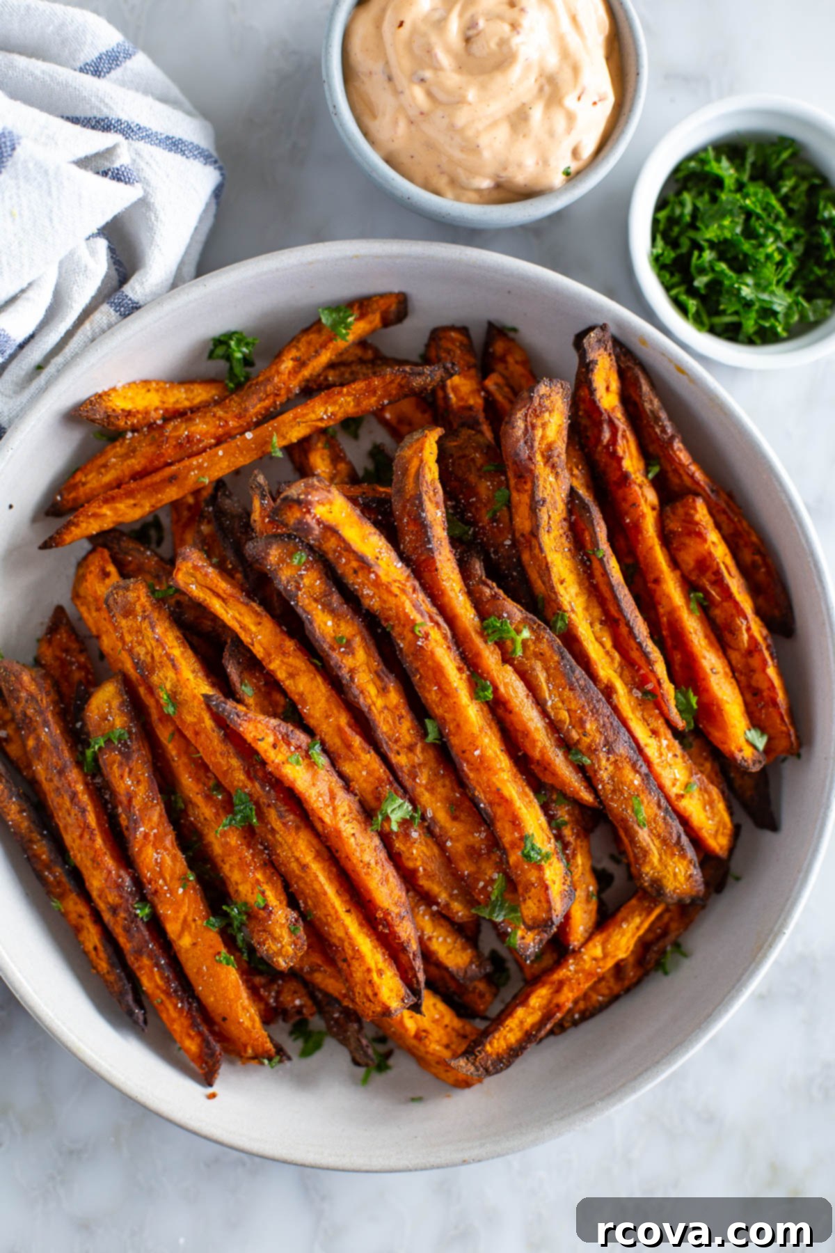 Guilt-Free Air Fryer Sweet Potato Gold 2 Overhead shot of perfectly crispy sweet potato fries served with a side of creamy chipotle dipping sauce