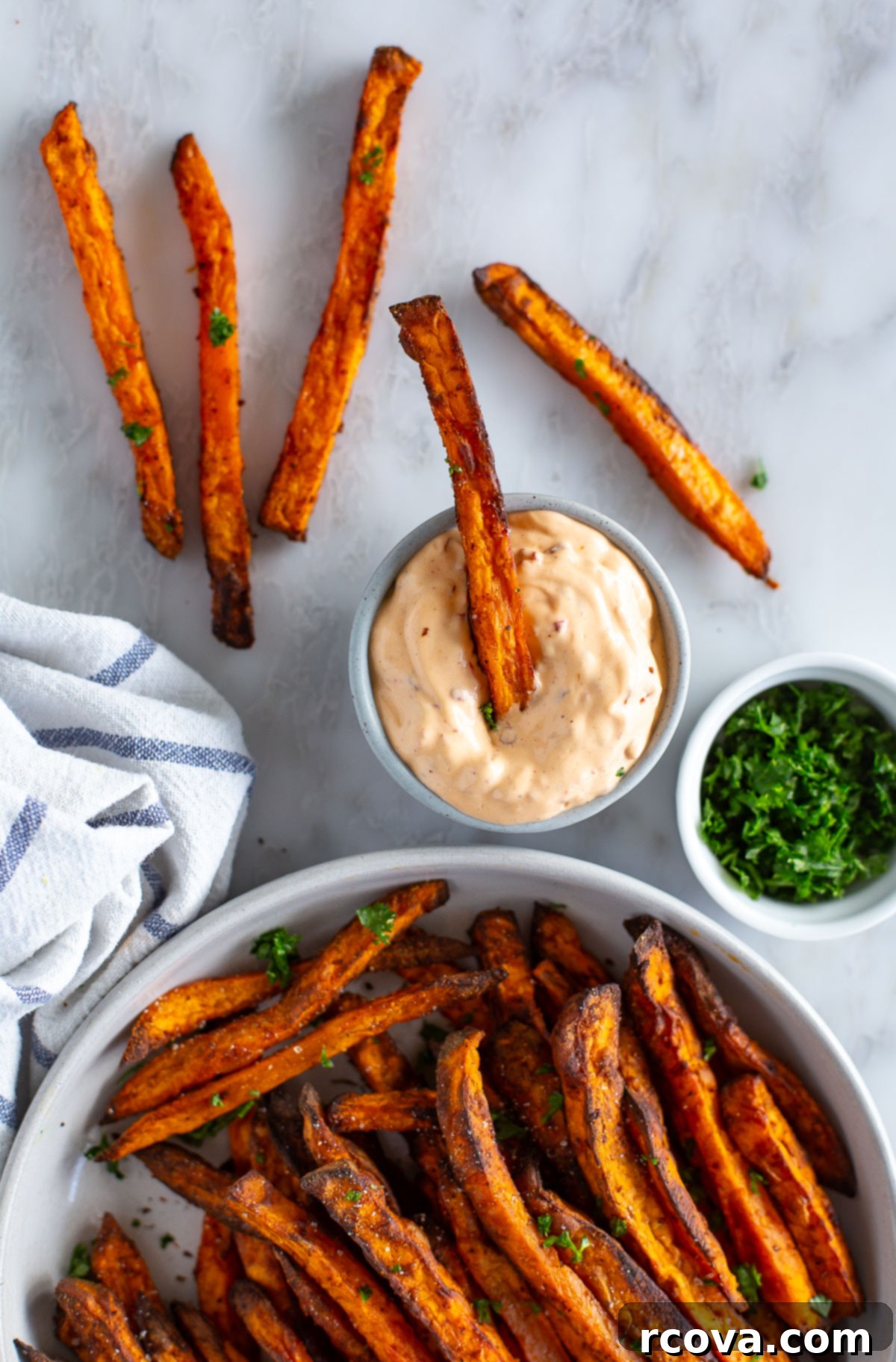 Guilt-Free Air Fryer Sweet Potato Gold 9 Sweet potato fries served in a bowl with a side of chipotle dipping sauce, ready to be enjoyed