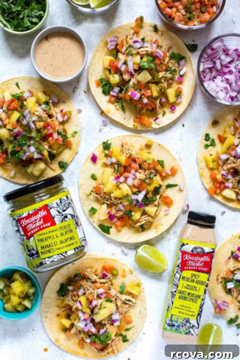 Tropical Crockpot Chicken Tacos with Pineapple Salsa 7 A plate of two Crockpot Chicken Tacos with pineapple salsa