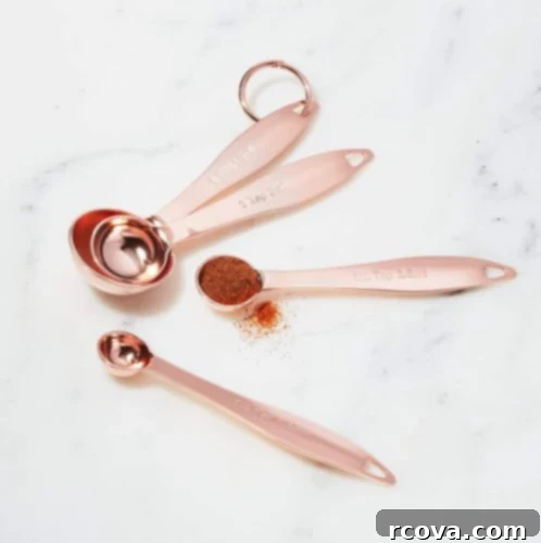 Culinary Curation: Gifts for Gourmet & Get-Ahead Cooks 6 Set of shiny copper measuring spoons, ideal for precision baking and a stylish kitchen.