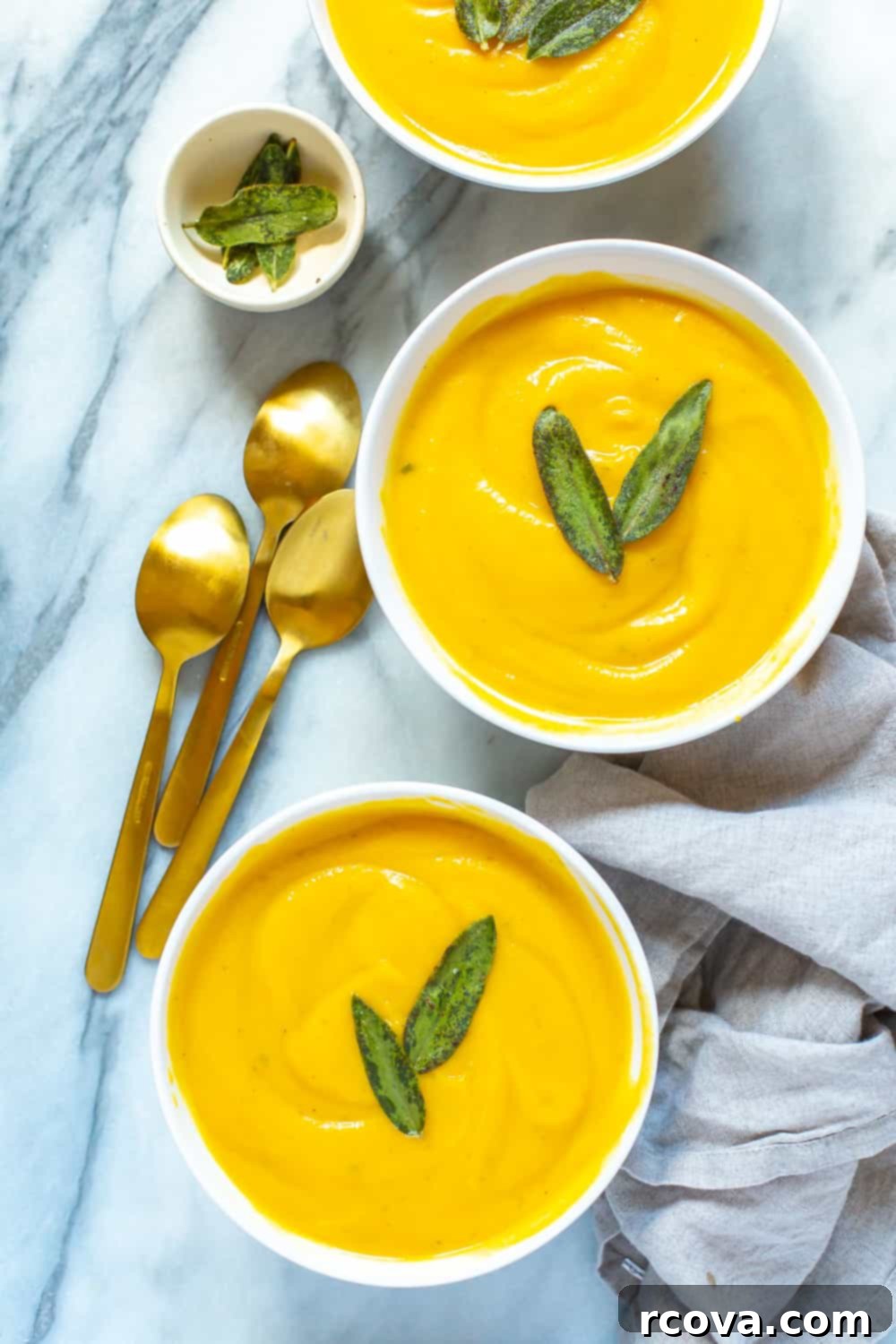 Autumn's Best: 40+ Butternut Squash Recipes to Savor 10 Three bowls of creamy butternut squash soup garnished with sage
