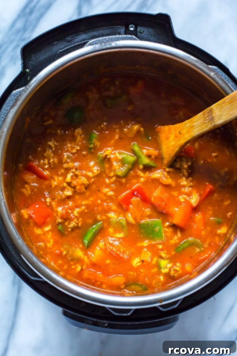 Instant Pot Unstuffed Pepper Soup 4 Instant Pot Stuffed Pepper Soup in a bowl, topped with cheese and parsley.