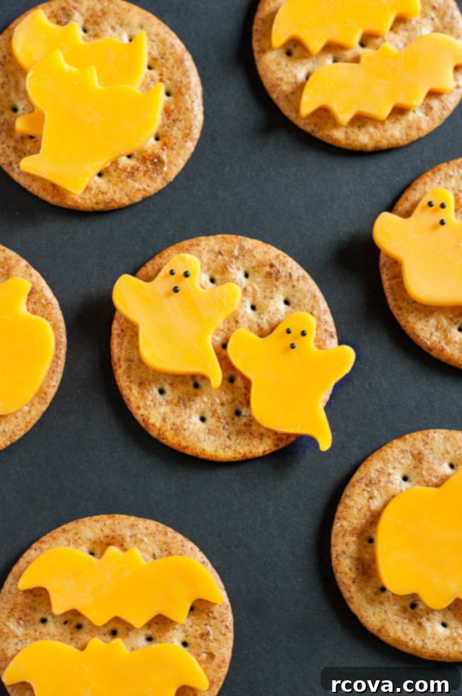 Wholesome Haunts: Healthy Halloween Feasts 7 Cheese cut into the shape of ghosts on crackers