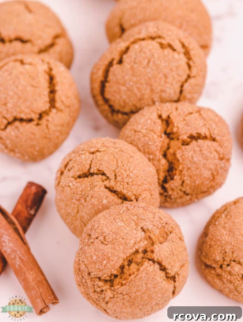 Spiced Pumpkin Gingersnap Cookies 10 A batch of pumpkin gingersnap cookies on a wooden board